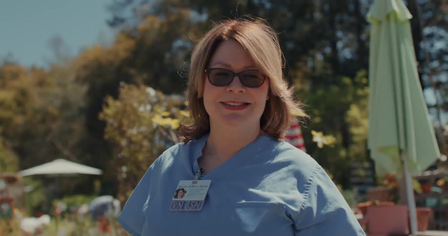 Portrait of a nurse smiling in an outdoor setting