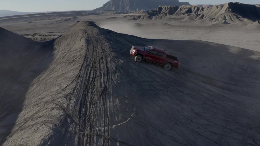 Pickup truck climbing a rocky hill in a natural environment