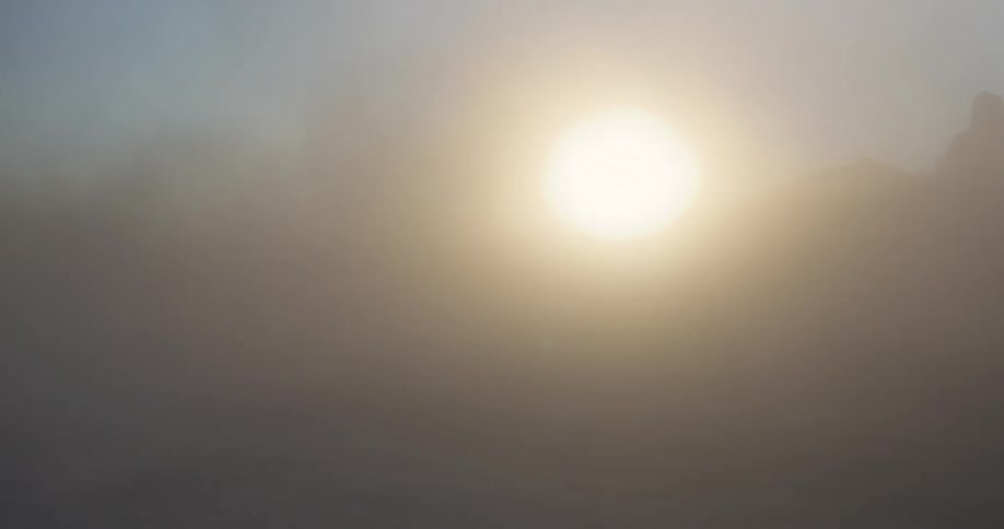 A sand storm quickly blows across the desert then dissipates