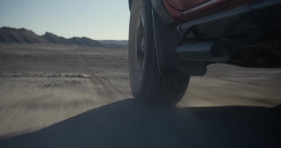 Wheel of a car traveling over dirt in a natural environment