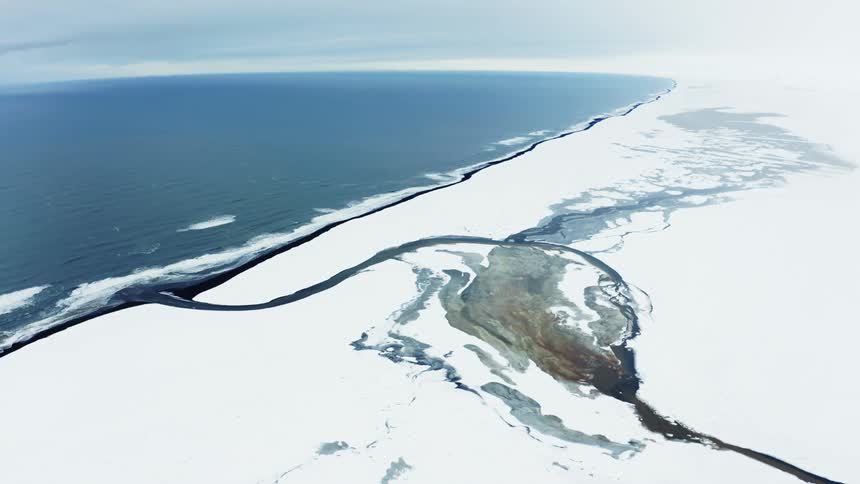 Aerial scenery of the arctic on the edge of an extensive sea and river channel