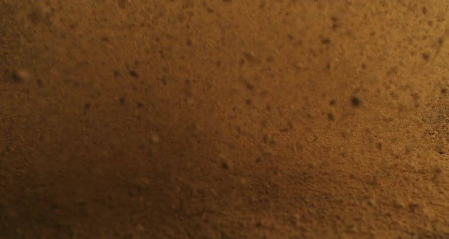 Close up of sand particles jumping up