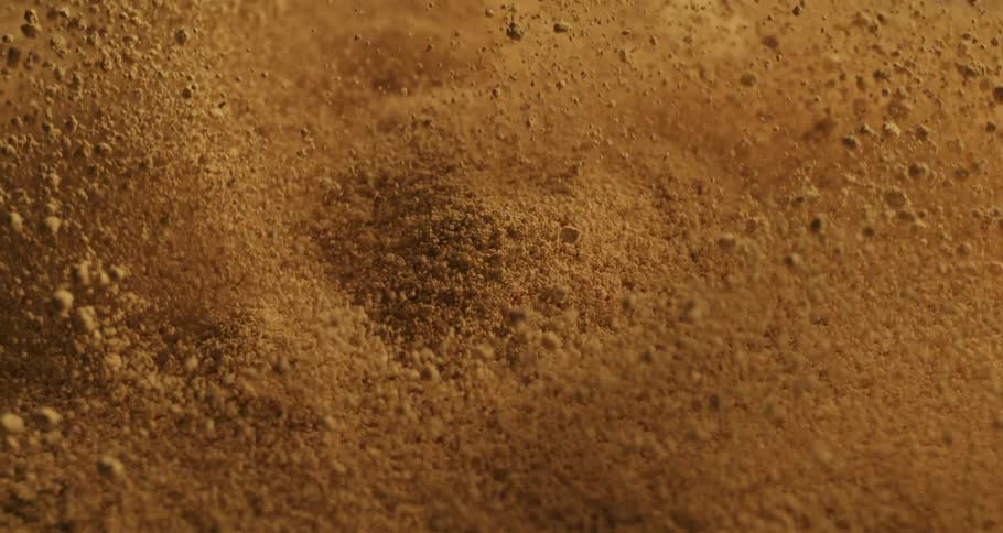 Closeup on an exploding sand floor in slow motion