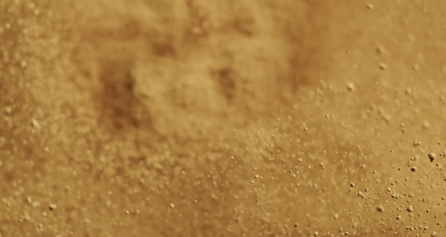 Close up of sand particles jumping up
