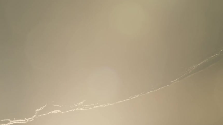 Extreme closeup on a rotating rock with strong abstract light