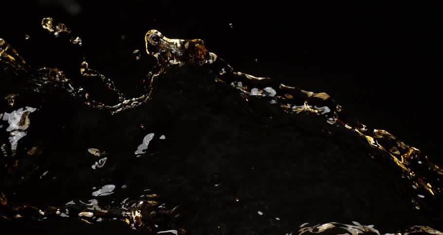 Extreme closeup of spilled liquid in slow motion