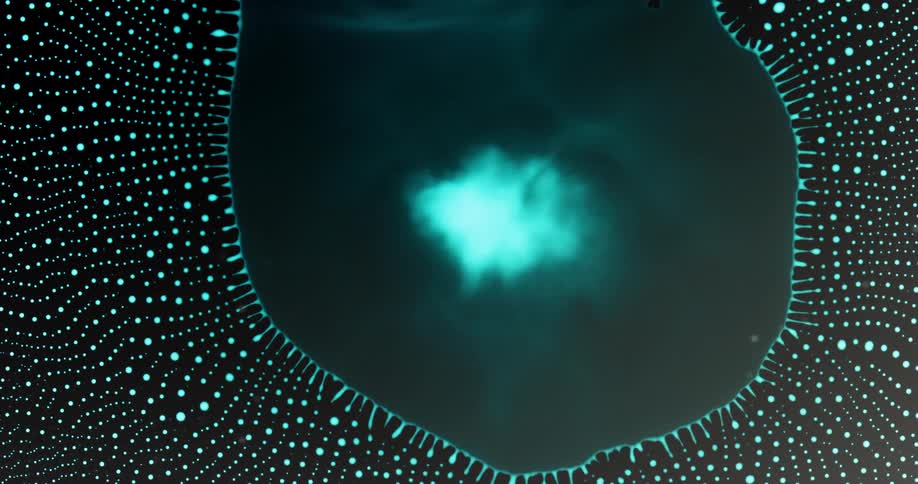 Extreme closeup of a circular blue liquid droplet collapsing into small abstract droplets