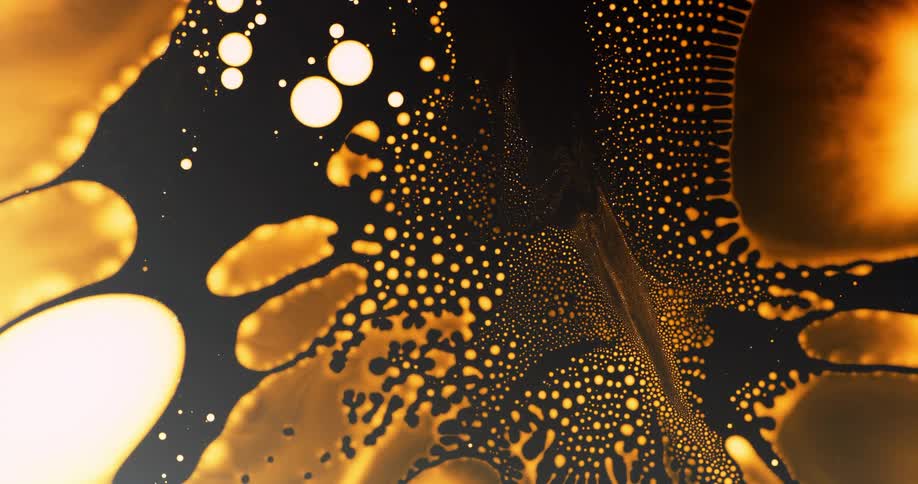 Abstract intricate pattern of moving golden liquid drops on a dark background