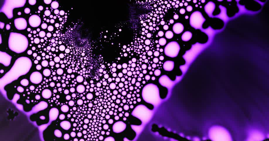 A purple aurora moves as pink orbs emerge in the darkness