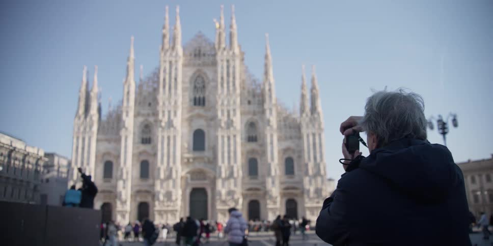 Tourists take photos of the Cathedral Duomo di Milano in Milan, Italy