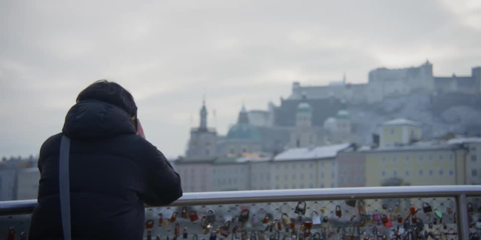 Tourist with his smartphone photographing Salzburg, Austria