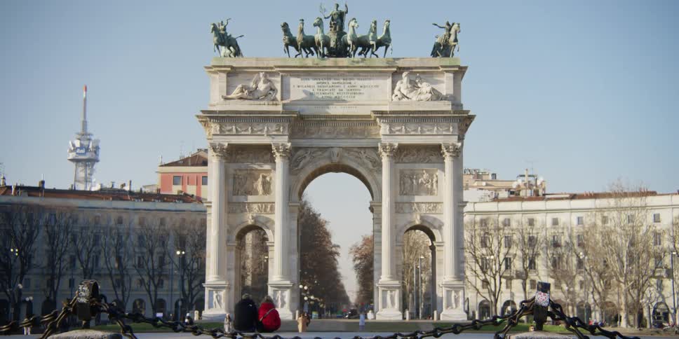 Pedestrians walk past the Arco della Pace in Milan on a winter day