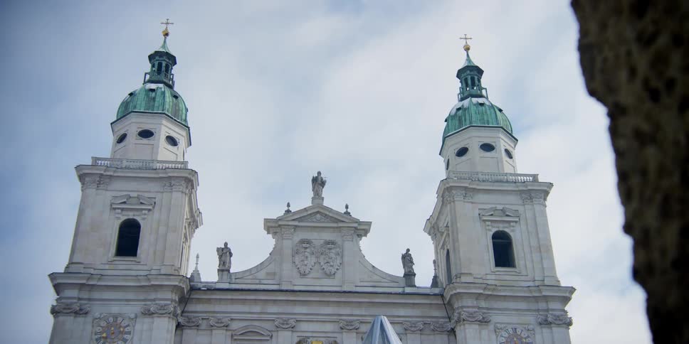 Front domed pillars of Salzburg Cathedral in Austria on a cloudy day