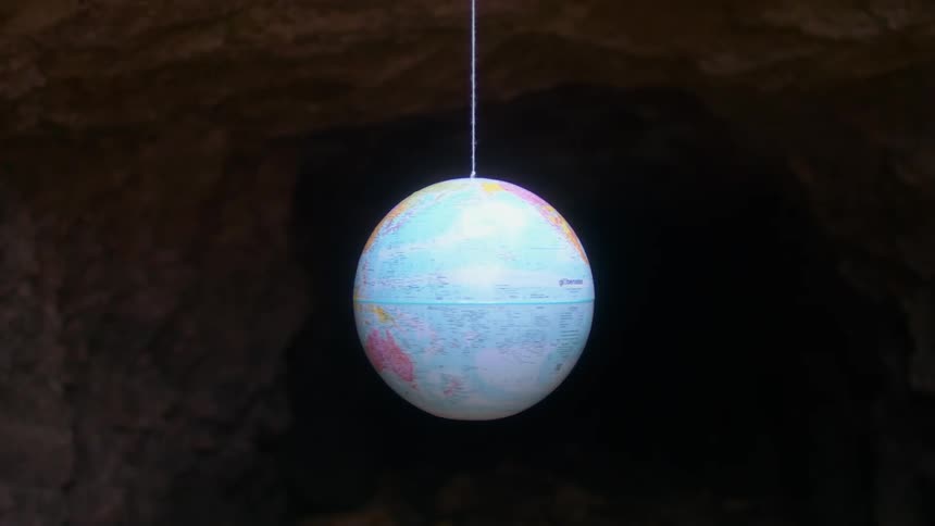 World globe of earth hanging on a string and spinning