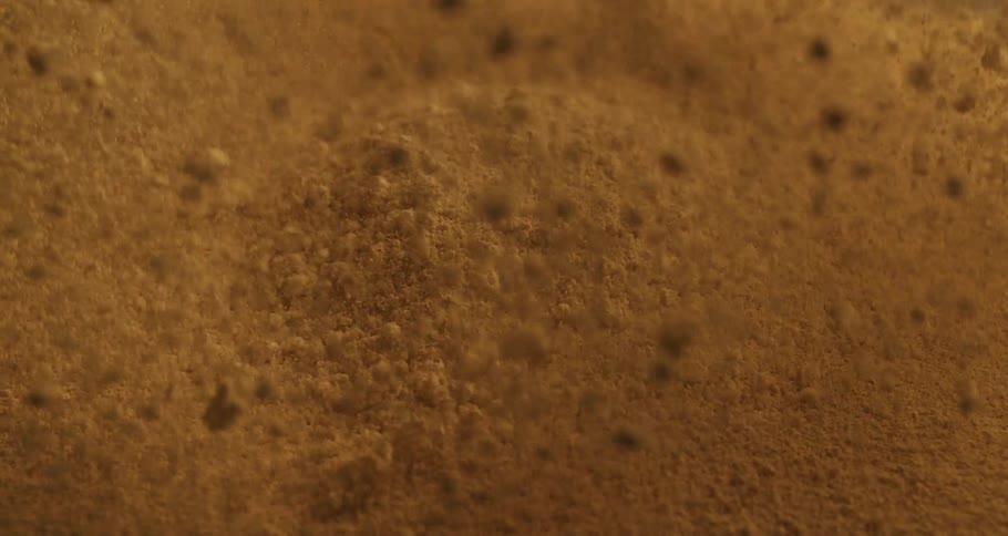 Close up of brown sand or dust jumping up