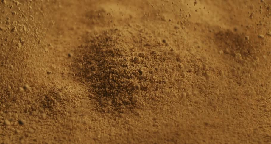 Closeup of the sand rising and falling after an explosion in slow motion