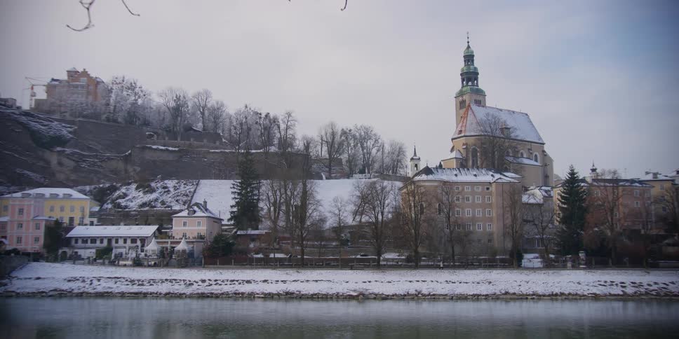 View of Mullner Kirche from across the Salzach River in Salzburg, Austria