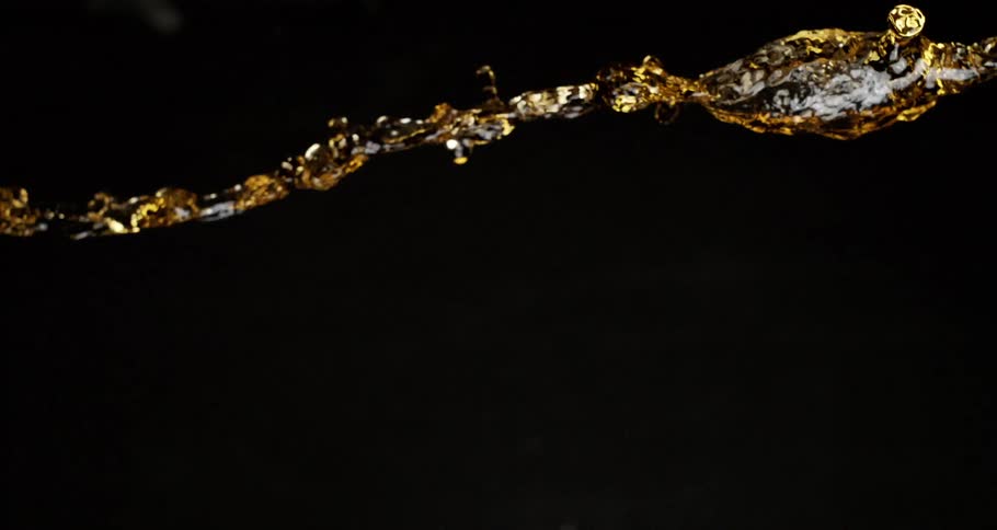 Liquid thrown into the air in slow motion on a black background