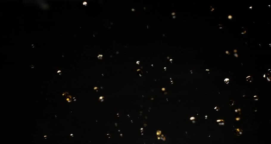 Abstract liquid splashes from left of frame to right and moves back in droplets