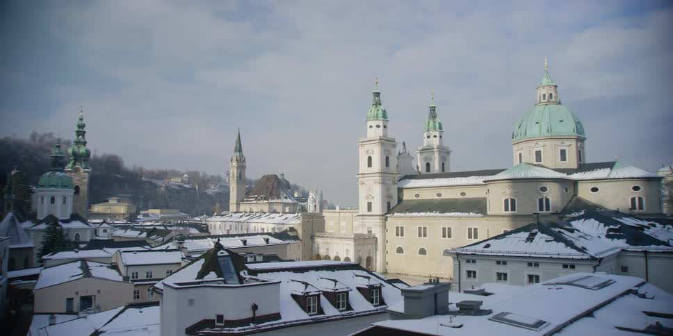 Winter panorama of old town neighborhood, cathedrals, domes, and spires in Salzburg, Austria