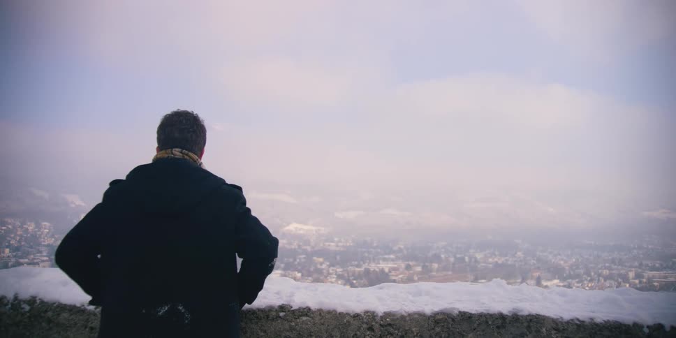 View from behind of a man overlooking Salzburg, Austria