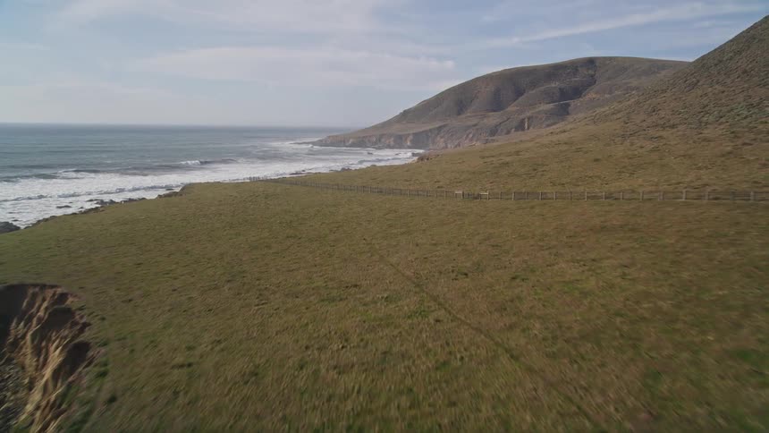 Waves wash ashore in a rural coastal area