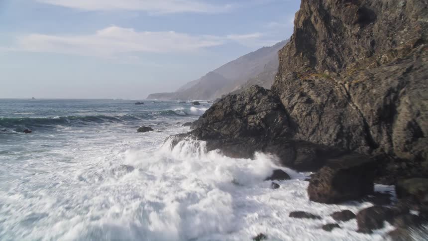 Natural scenery of sea waves hitting the rocks on the coast