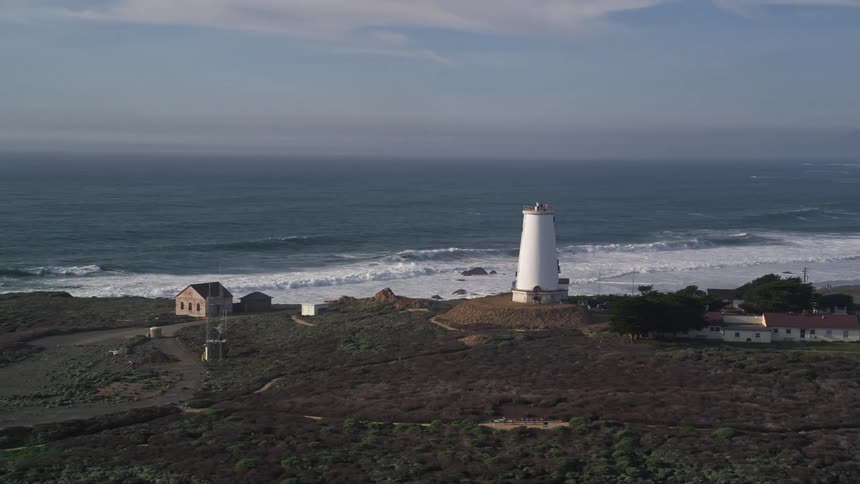 A light house is on the shore of the island