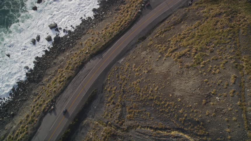 A car driving on a coastal road