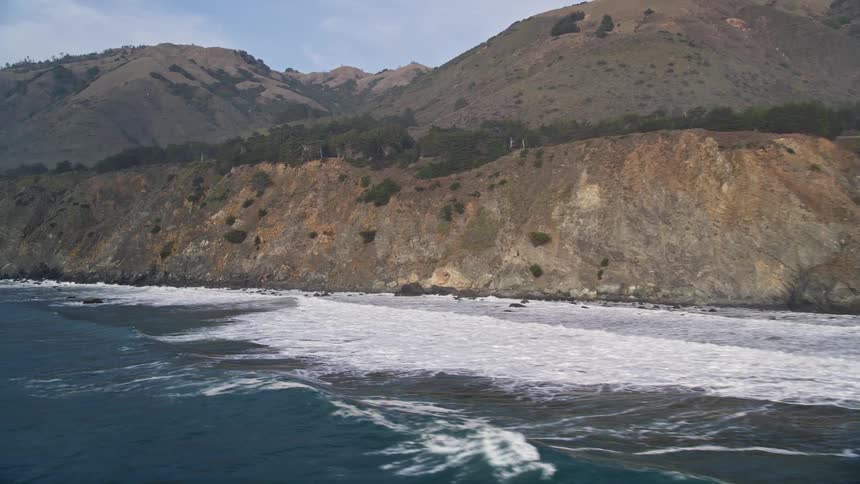 Strong waves hitting coastal mountains