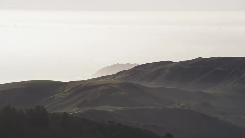 Aerial landscape of vegetation and greenish mountain ranges in a morning