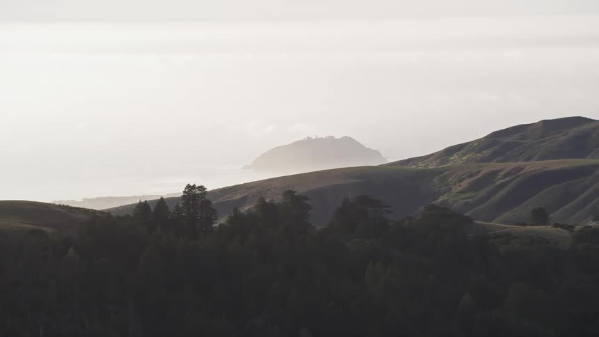 Panorama of mountains with lush vegetation with ocean in the background