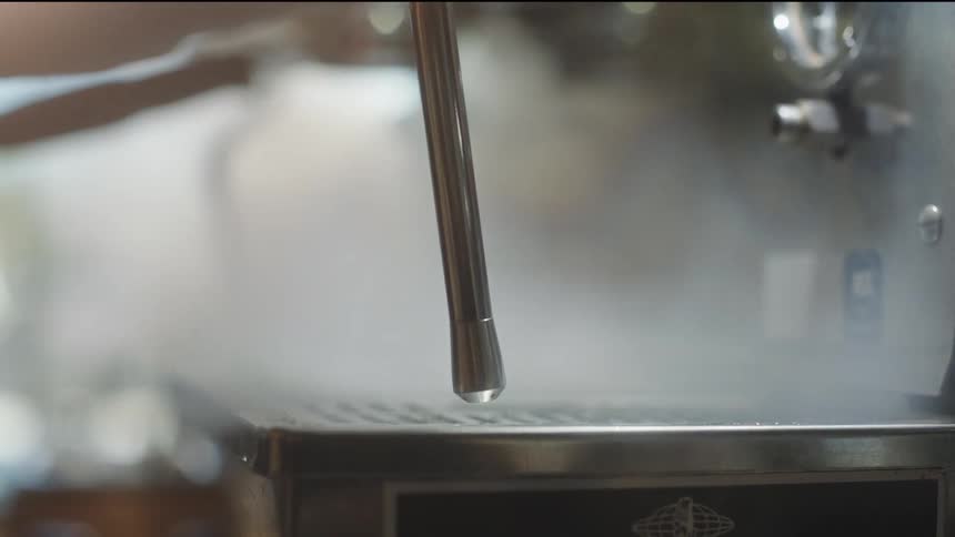 A steamer shoots steam into a metal grate