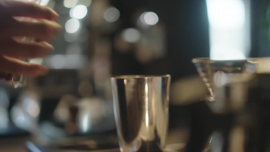 Man hands putting coffee beans into a metal cup