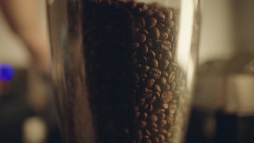 Closeup of a pot being filled with coffee beans