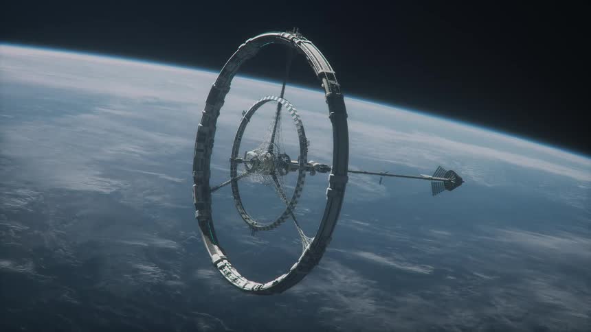 A large space station rotating as it orbits earth