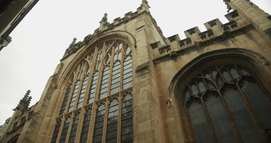Elaborate architectural ornamentation decorates exterior of cathedral with large arched windows