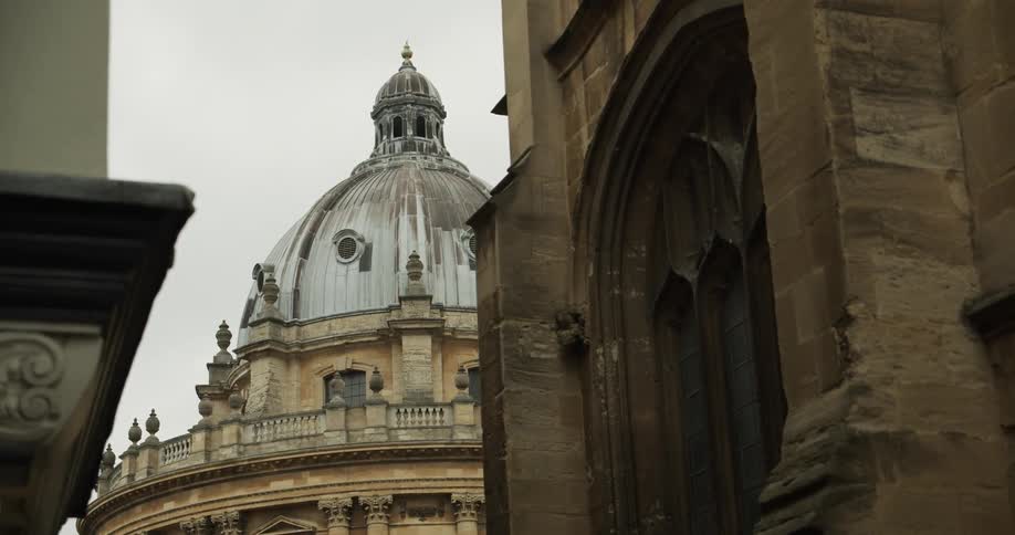 Exterior architecture of the radcliffe camera with a dome on a cloudy day