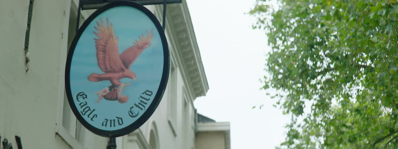 Sign with an eagle on a blue background of an establishment in the city