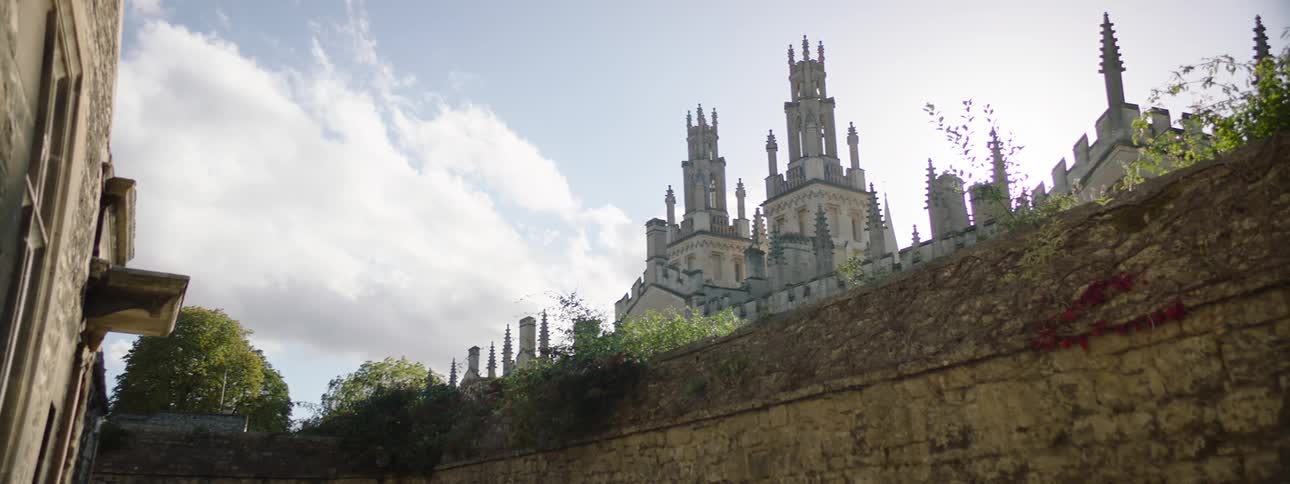 Scenery of an urban city with towers of a castle with forts on a blue sky day with clouds
