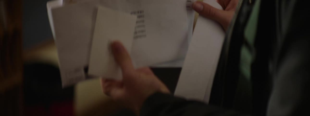 Womans hands checking envelopes and letters
