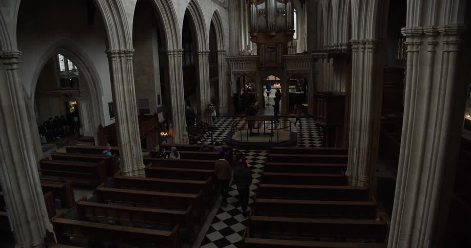 Interior view of a cathedral with benches and seats and columns around