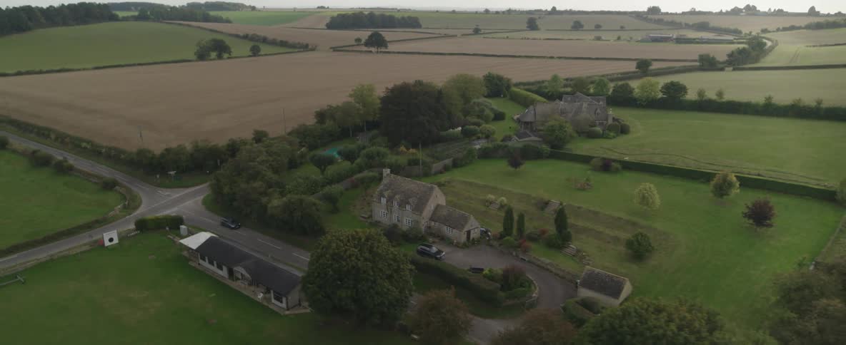 A vehicle drives through a very rural area