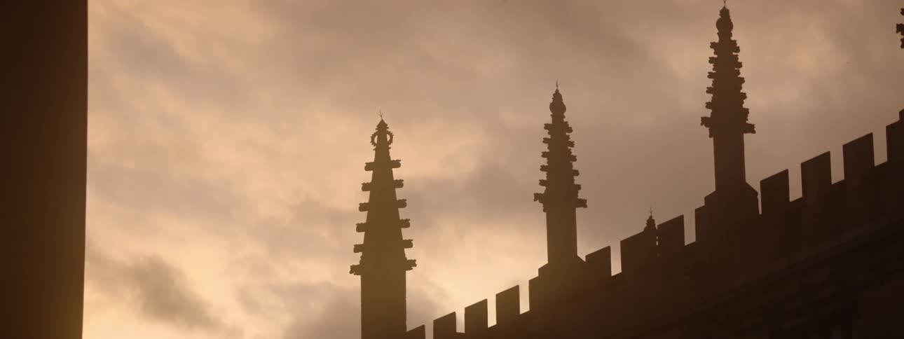 The facade of the building is dark at sunset