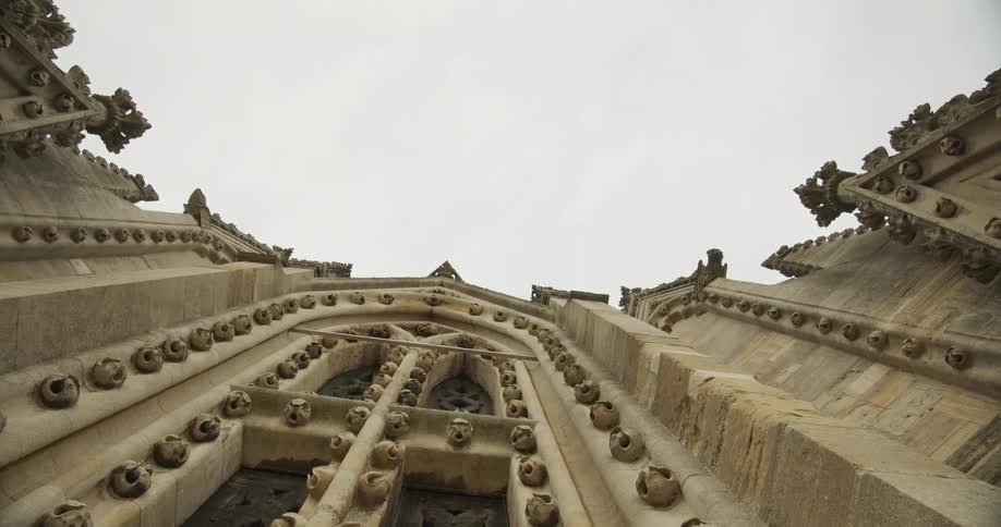 Facade of the university church in oxford covered in ball flowers