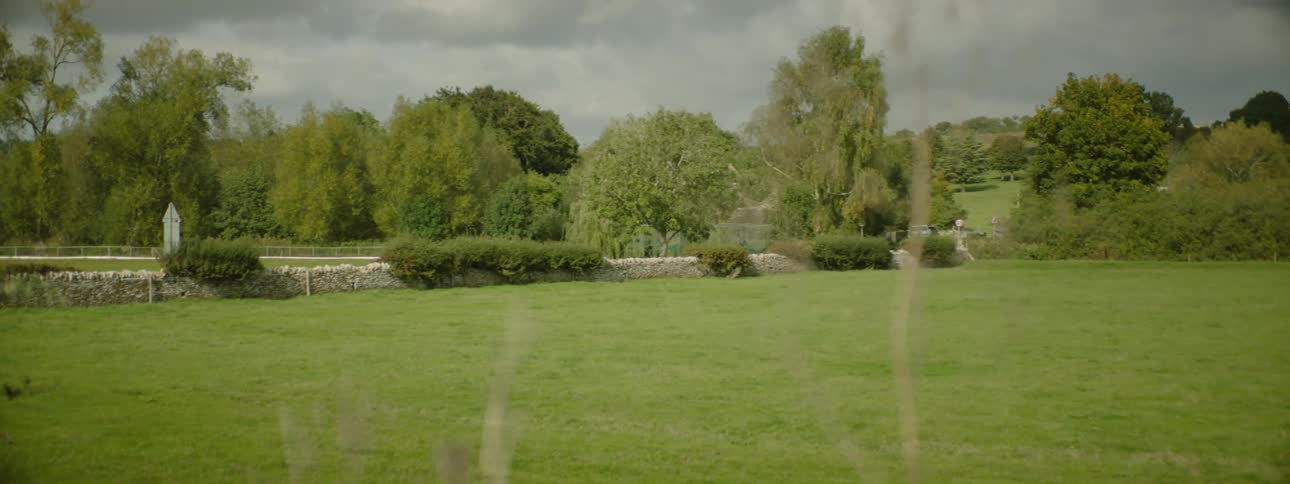 A car drives past the field