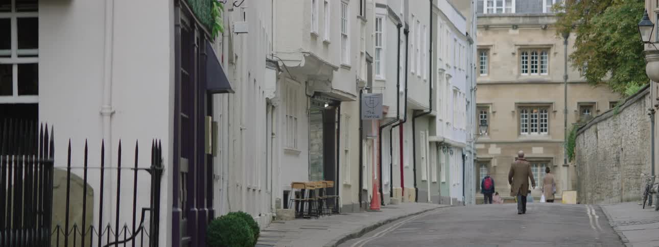 Street of a suburban city with a pedestrian during the day