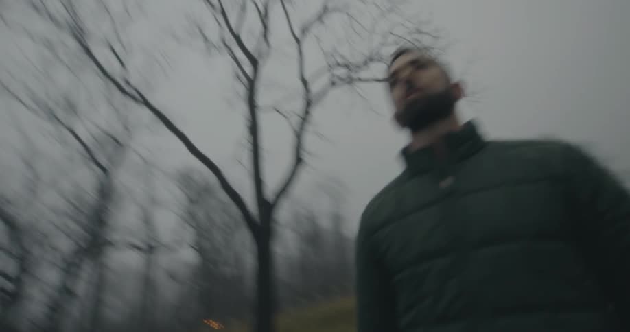 Man with jacket in a natural winter environment sanctifying and warming his body