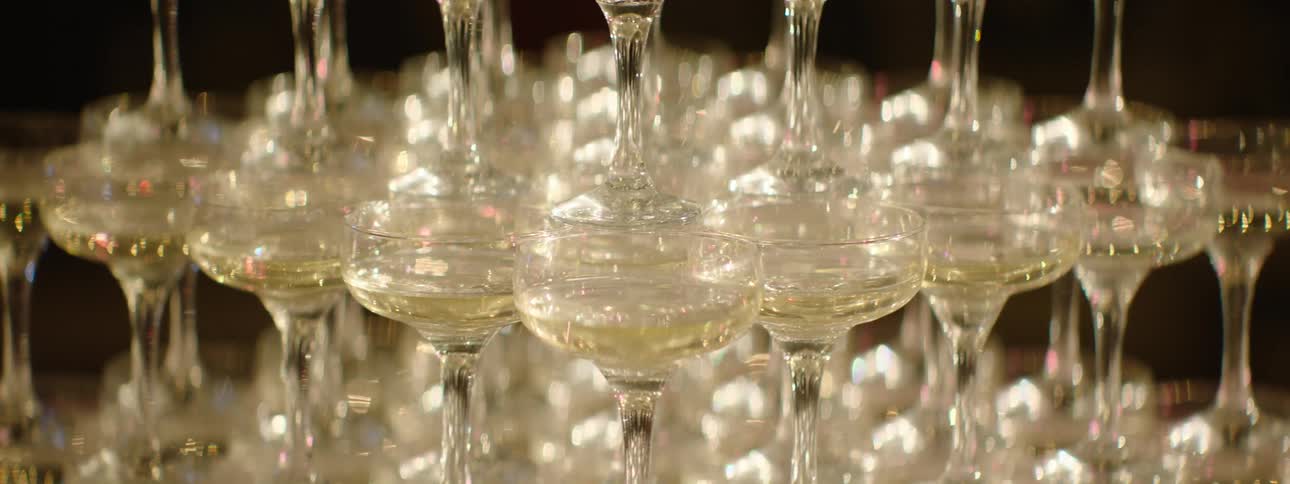 Crystal glasses with drinks and cocktails stacked on top of each other