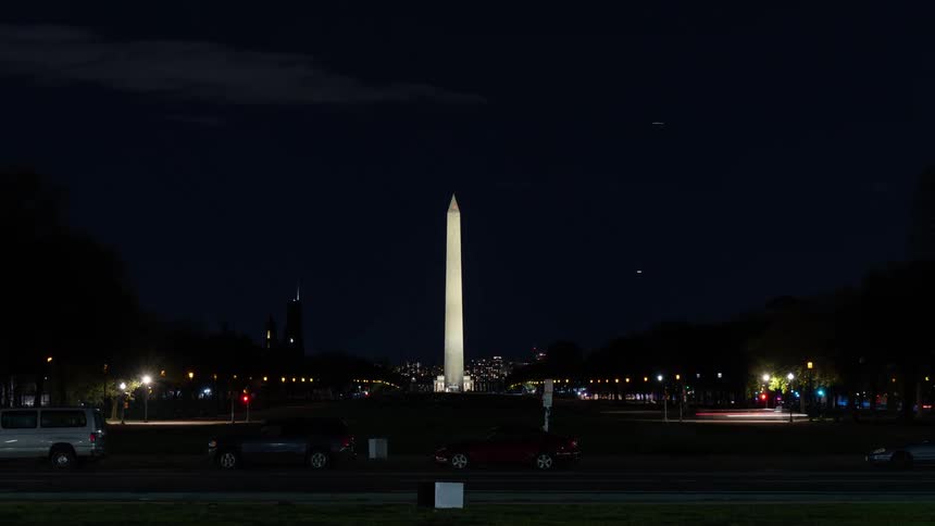 People and traffic move in an area near the washington monument